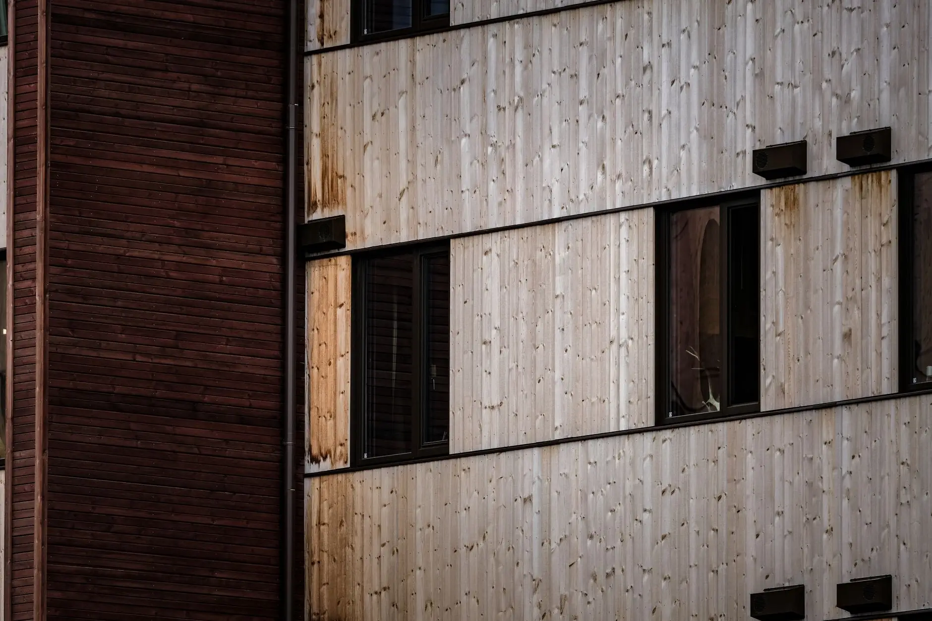 Close-up of vertical timber cladding boards around a recessed window